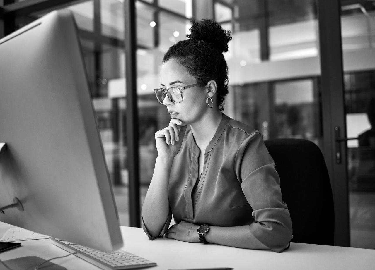 Young woman in front of computer monitor Young woman in front of computer monitor concentrating on a task